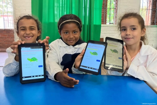 Photo of kids learning on tablets