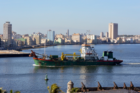 Photo of Cargo Ship Entering Bay at Sunrise