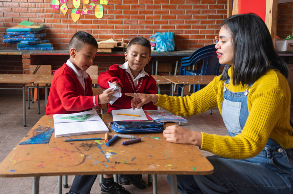 Photo of teacher playing and instructing children